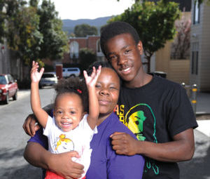 family smiling in residential neighborhood