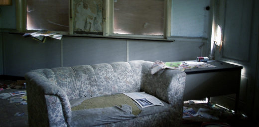 An old couch in an abandoned building