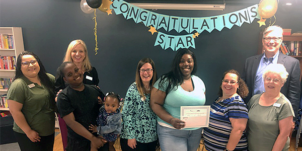 EPIC grant recipient, Starisha White, family, MHL staff and Mark Angelini, MHL President