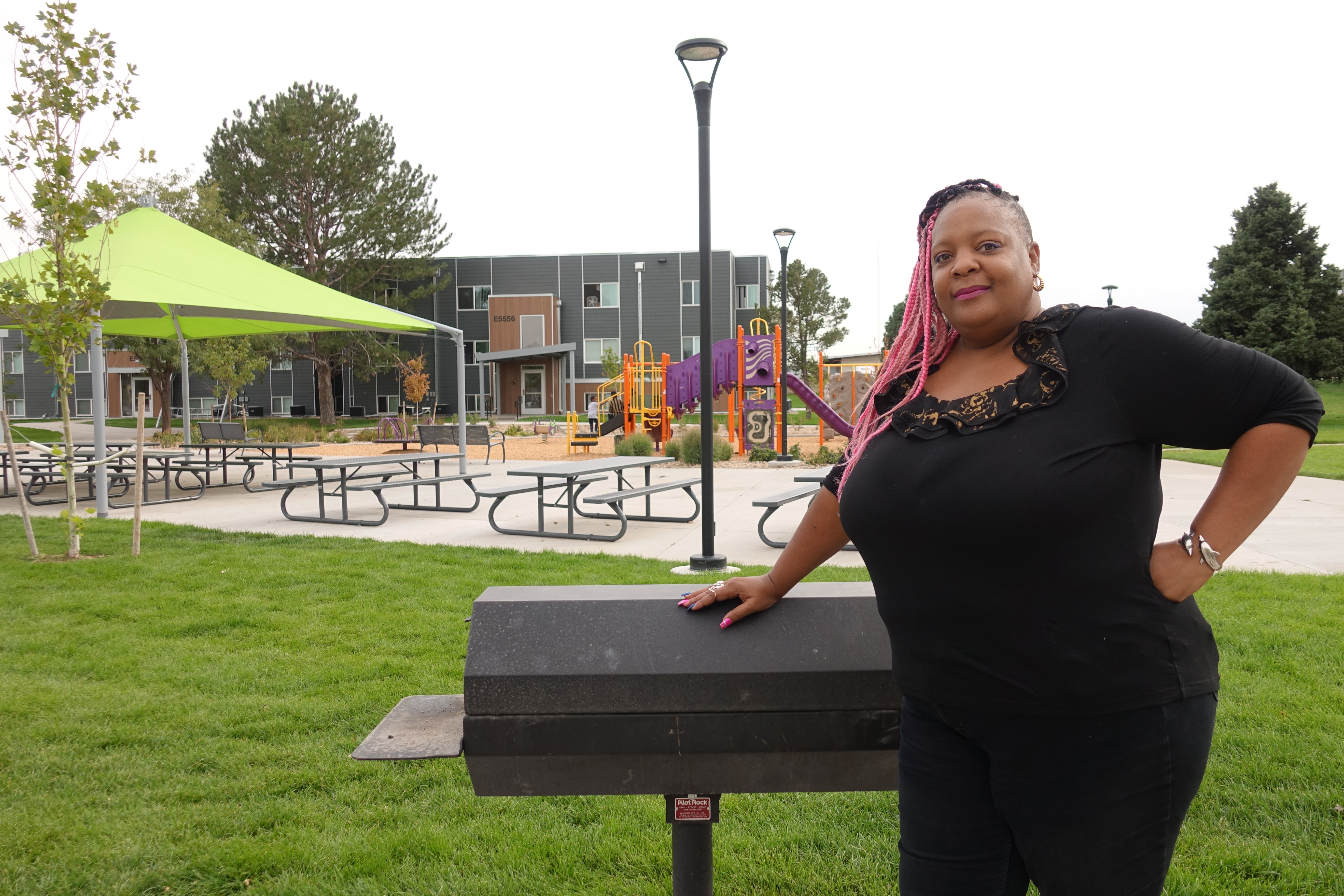 gina in front of a BBQ at Holly Park