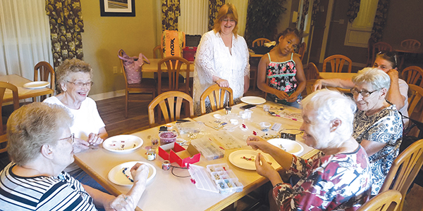 Seniors at Assisi Homes of Kenosha enjoyed working with a volunteer to make their own jewelry.