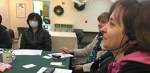 A group of residents using the headset translation devices.