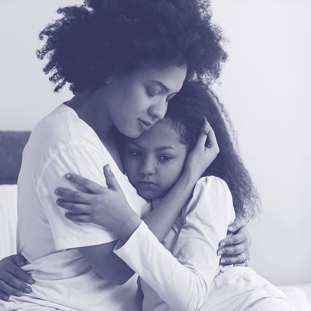 Mother hugging daughter
