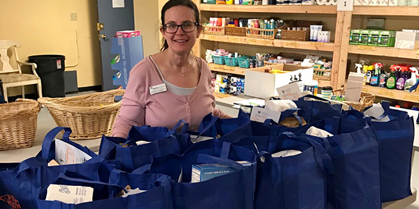 woman in front of food donations