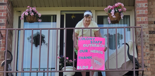 Woman on balcony with sign