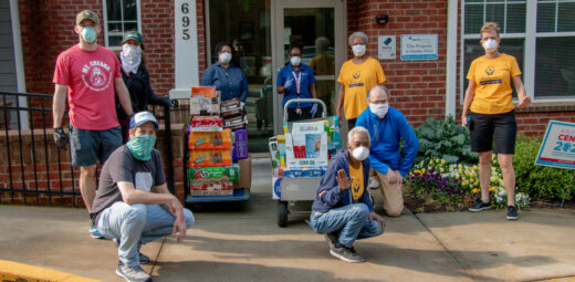 Volunteers pose with donated goods