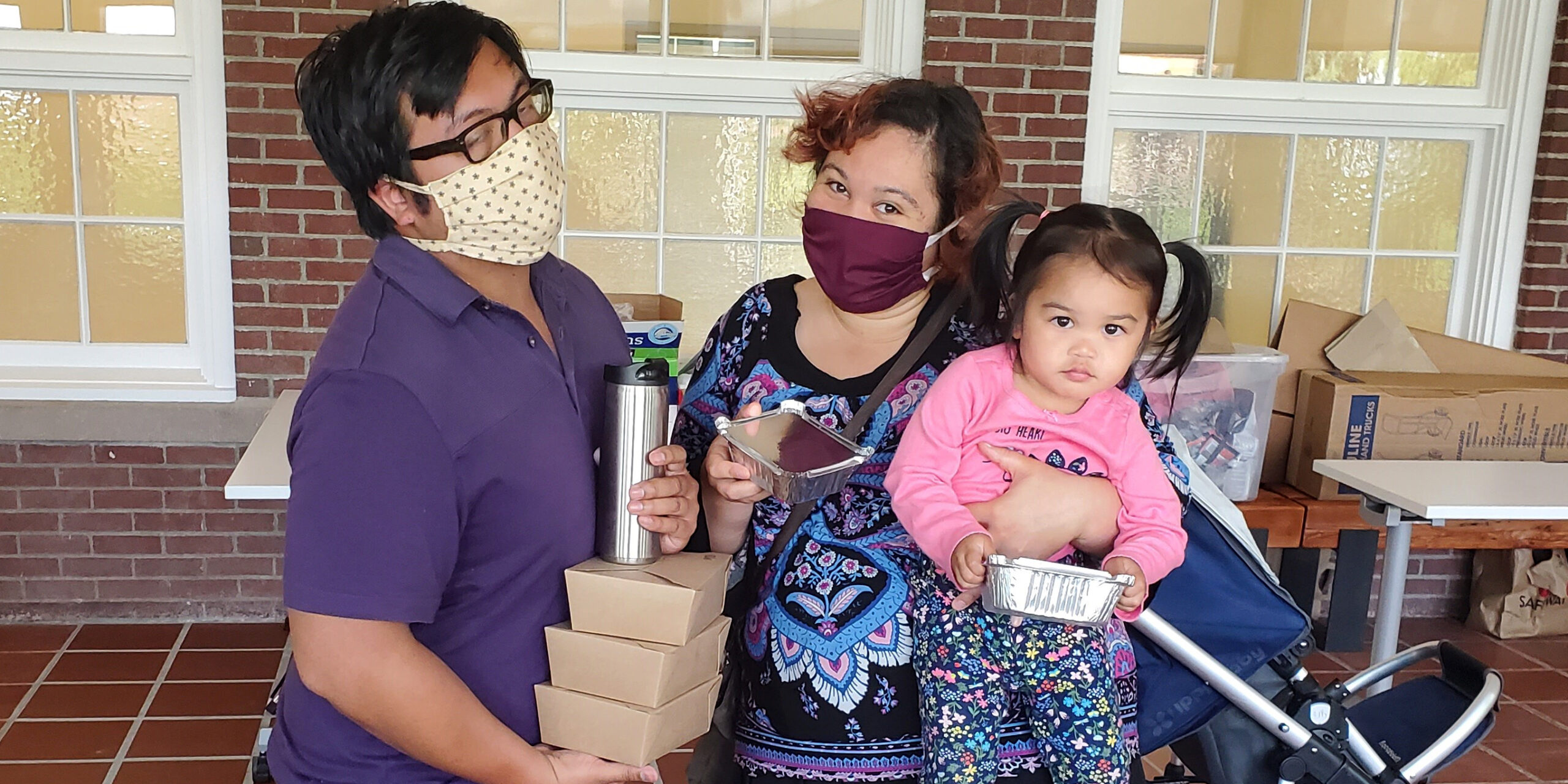 Family receiving meal delivery from Mercy Housing Northwest