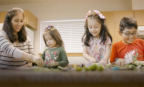 Mercy Housing Resident Emma and her children cooking together