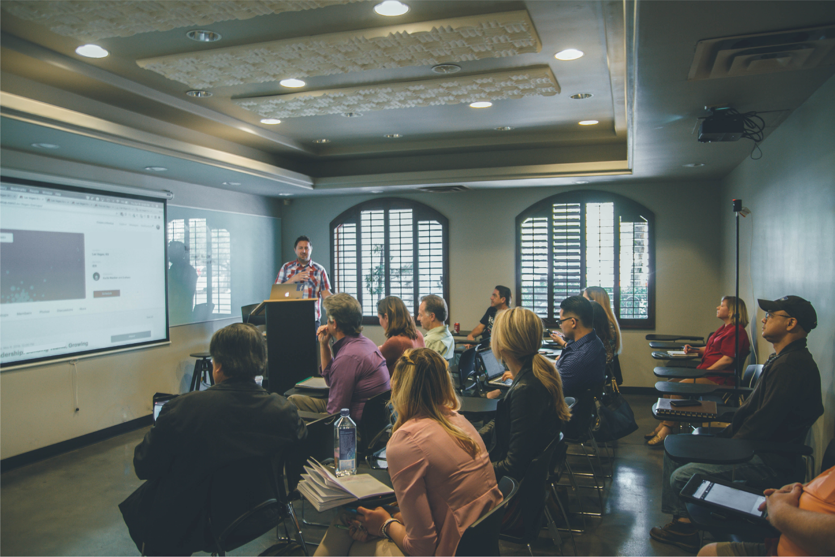 A photo of people sitting at a presentation